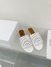 ALAIA VIENNE FLAT MULES IN WHITE LAMBSKIN