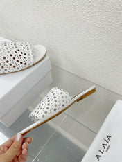 ALAIA VIENNE FLAT MULES IN WHITE LAMBSKIN