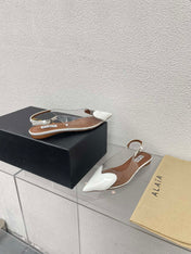 ALAIA LE COEUR FLAT SLINGBACKS IN WHITE PATENT LAMBSKIN