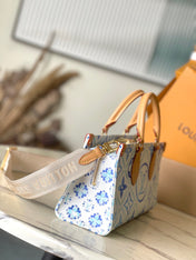 ONTHEGO EAST WEST 25 IN LAGOON BLUE MONOGRAM TILES CANVAS