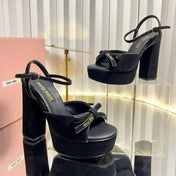 MIUMIU 26S PLATFORM ANKLE STRAP SANDALS 120MM IN BLACK SUEDE WITH BOW