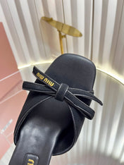 MIUMIU 26S MULE SANDALS 55MM IN BLACK SUEDE WITH BOW
