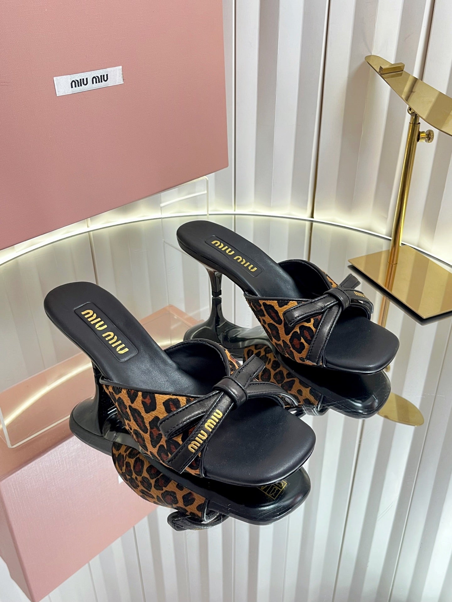 MIUMIU 26S MULE SANDALS 55MM IN LEOPARD PRINT CALF HAIR WITH BOW