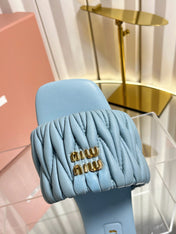 MIUMIU 26S MATELASSE SLIDES IN LIGHT BLUE CALFSKIN GOLD HARDWARE