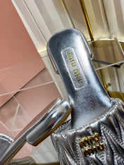 MIUMIU 26S MATELASSE SLIDES IN SILVER CALFSKIN GOLD HARDWARE