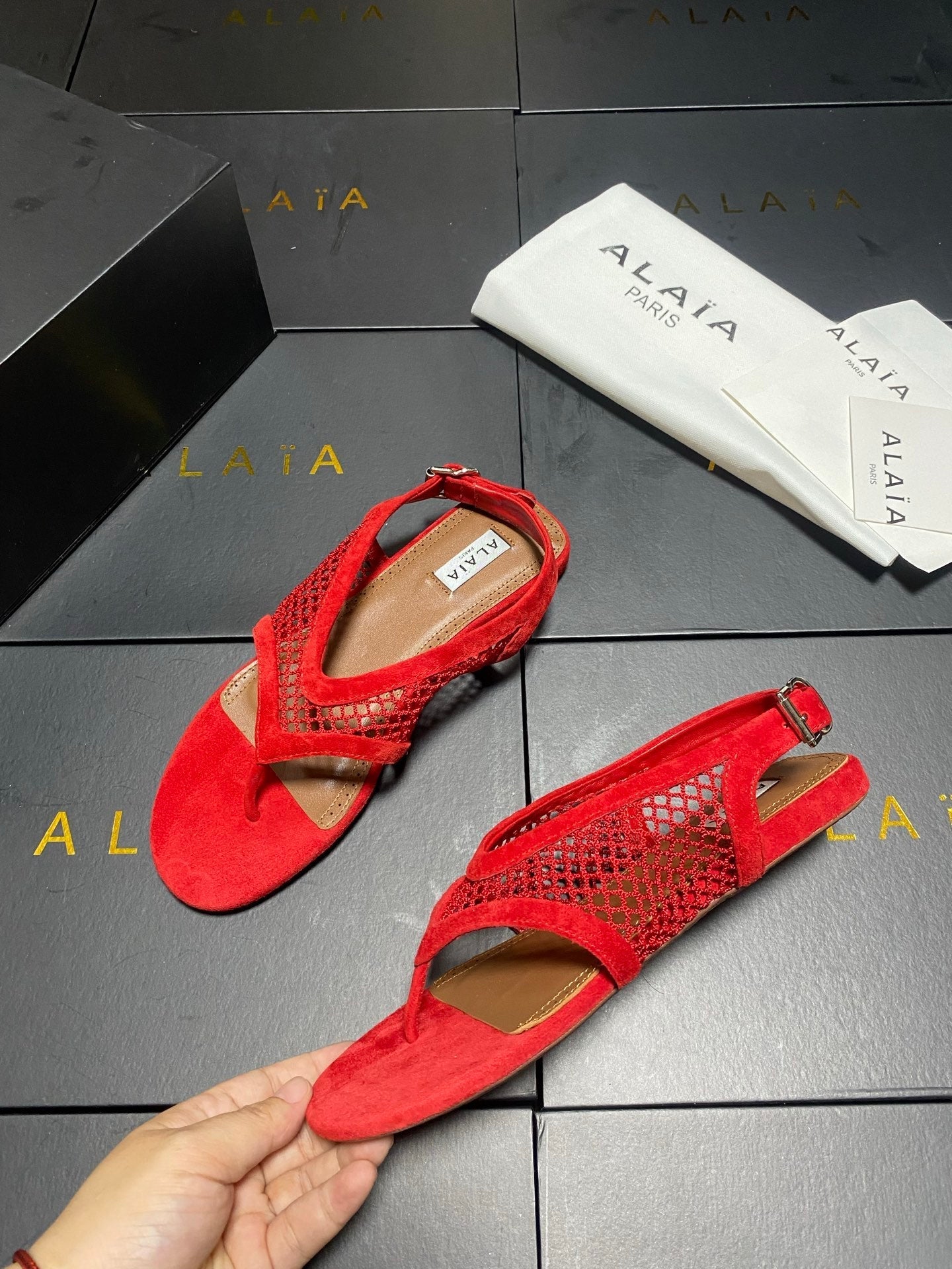 ALAIA 26S FLAT MESH THONG SANDALS IN RED SUEDE
