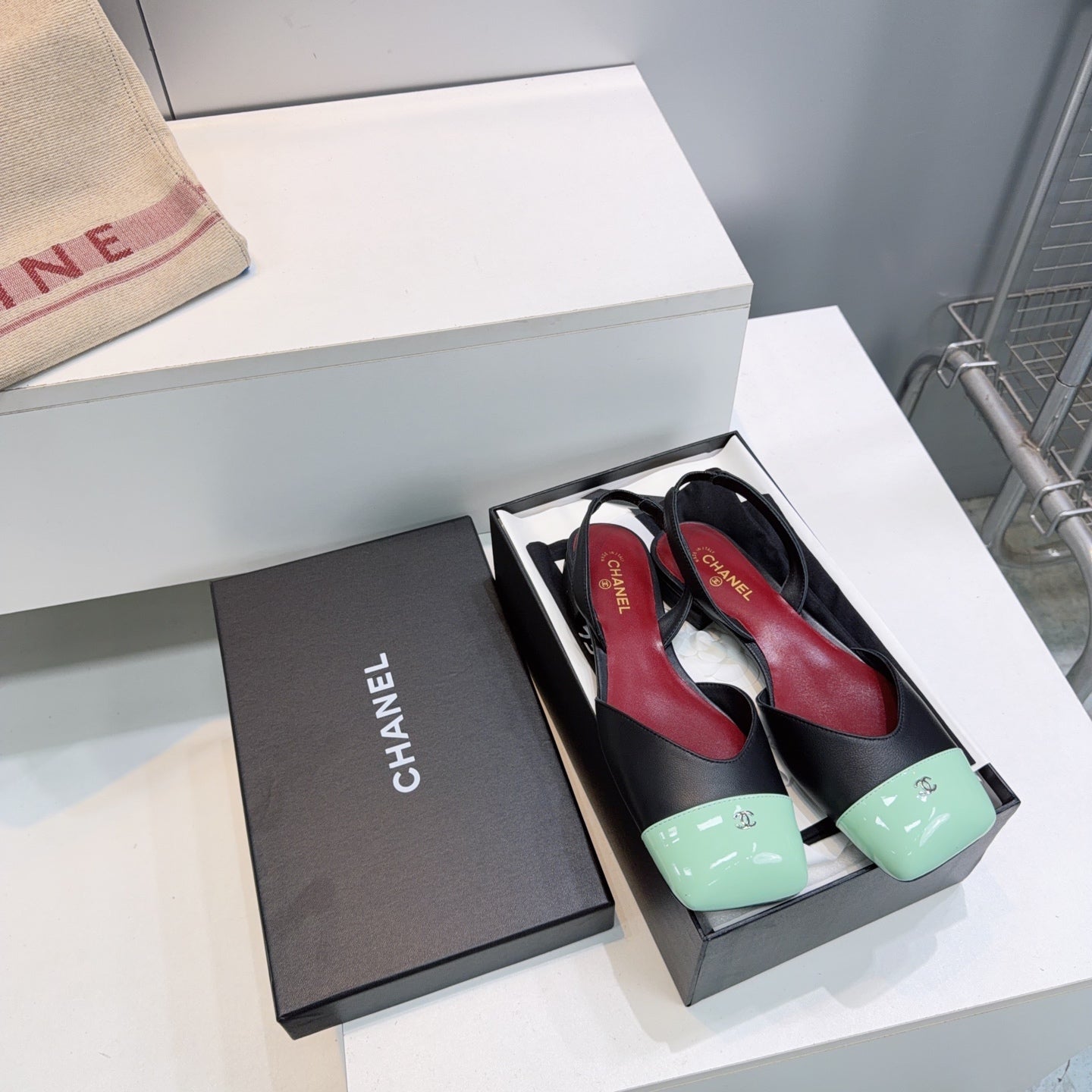 CHANEL 26S FLAT SLINGBACK IN BLACK LAMBSKIN WITH MINT GREEN CAP TOE