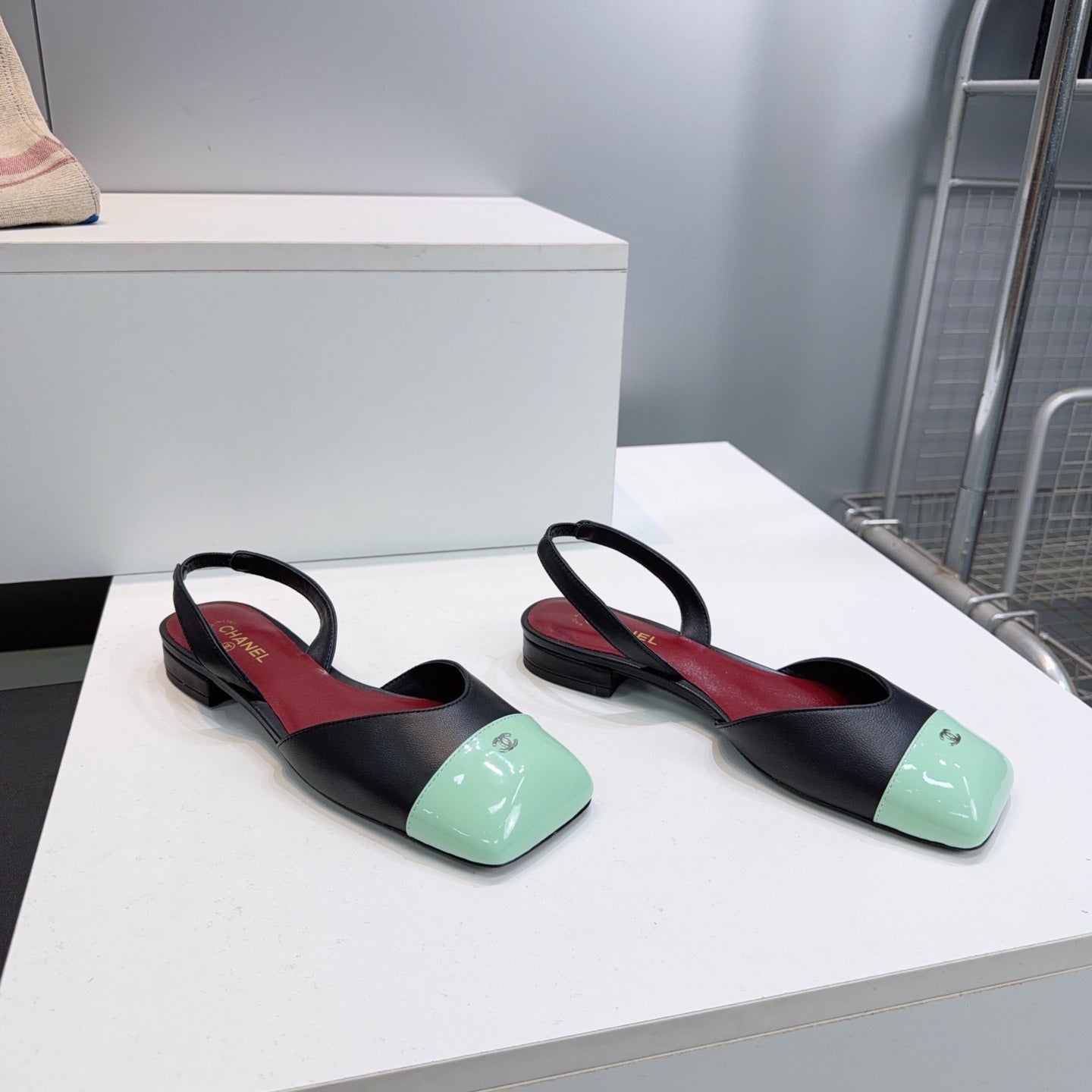CHANEL 26S FLAT SLINGBACK IN BLACK LAMBSKIN WITH MINT GREEN CAP TOE