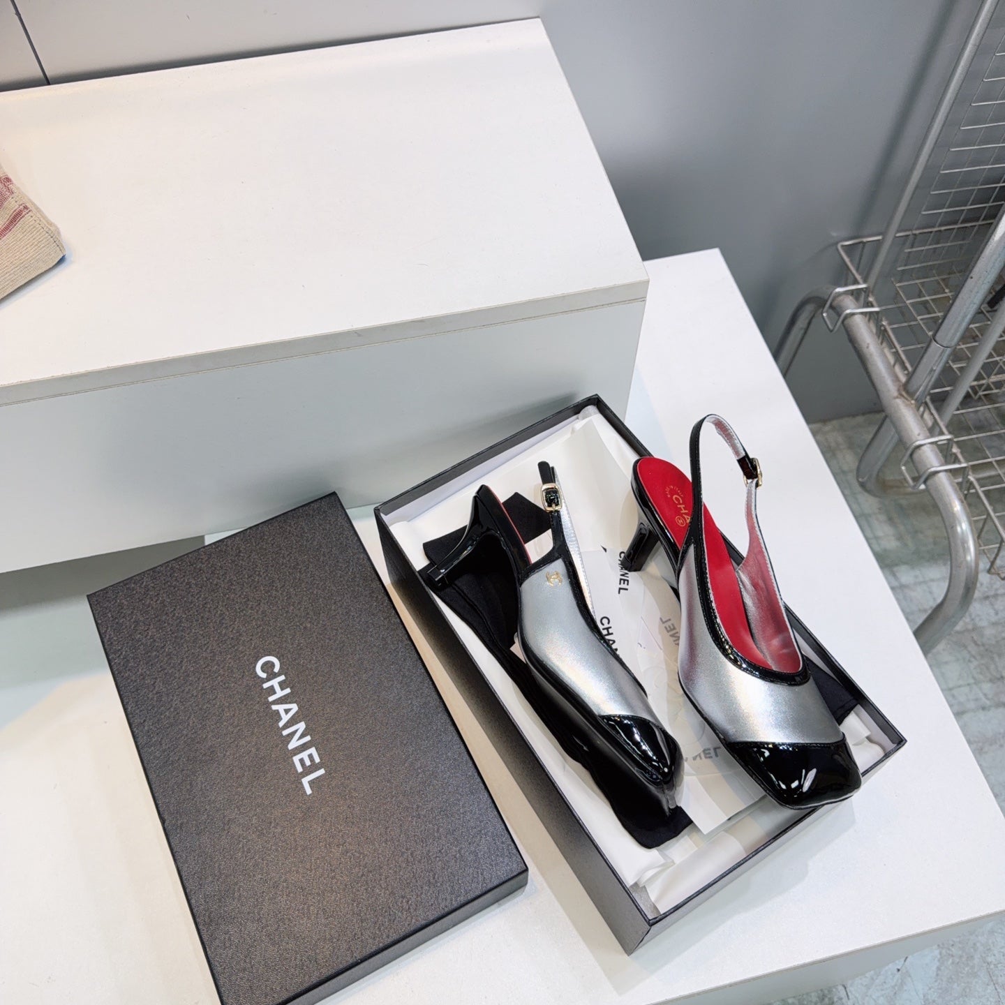 CHANEL 26S HIGH HEEL SLINGBACK PUMPS 65 MM IN BLACK AND SILVER LAMBSKIN