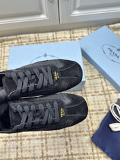 PRADA 26S LOW TOP SNEAKERS IN BLACK NYLON AND SUEDE