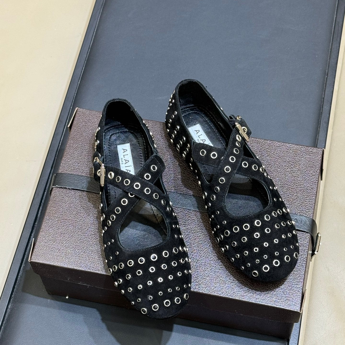 ALAIA 26S CROSS-STRAP FLATS IN BLACK SUEDE WITH SILVER HARDWARE