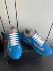 PRADA 26S AMERICA CUP SNEAKERS IN AZURE BLUE SOFT RUBBER AND BIKE FABRIC