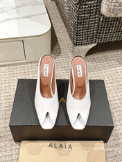 ALAIA SPIKE JEWEL MULES IN WHITE CALFSKIN