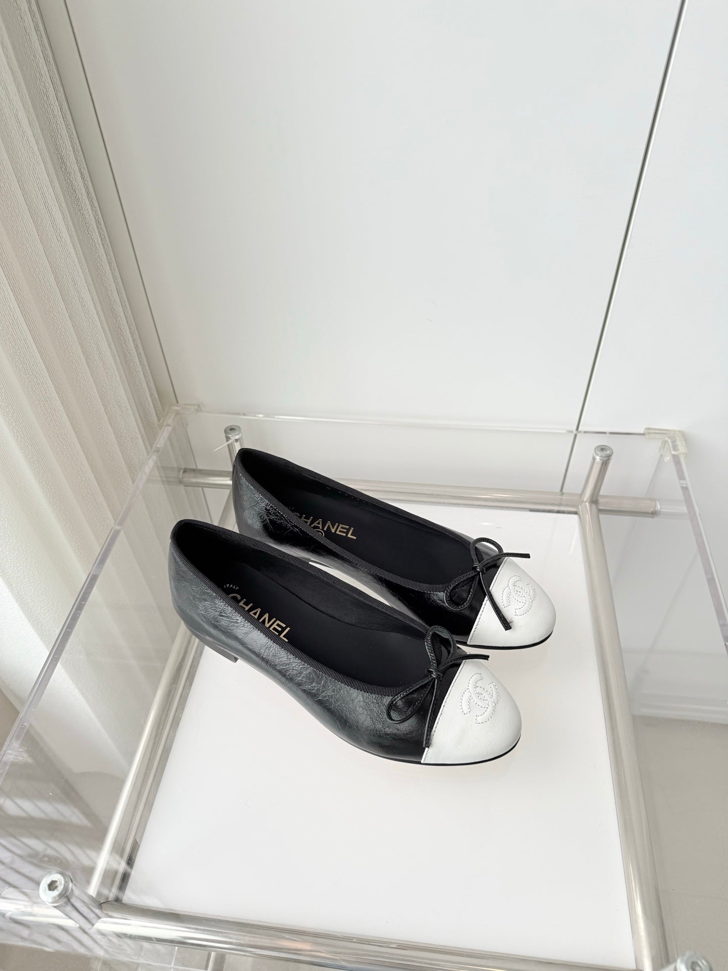 CHANEL 26S BALLET FLATS IN BLACK CRACKED CALFSKIN WITH WHITE TOE CAP AND BOW