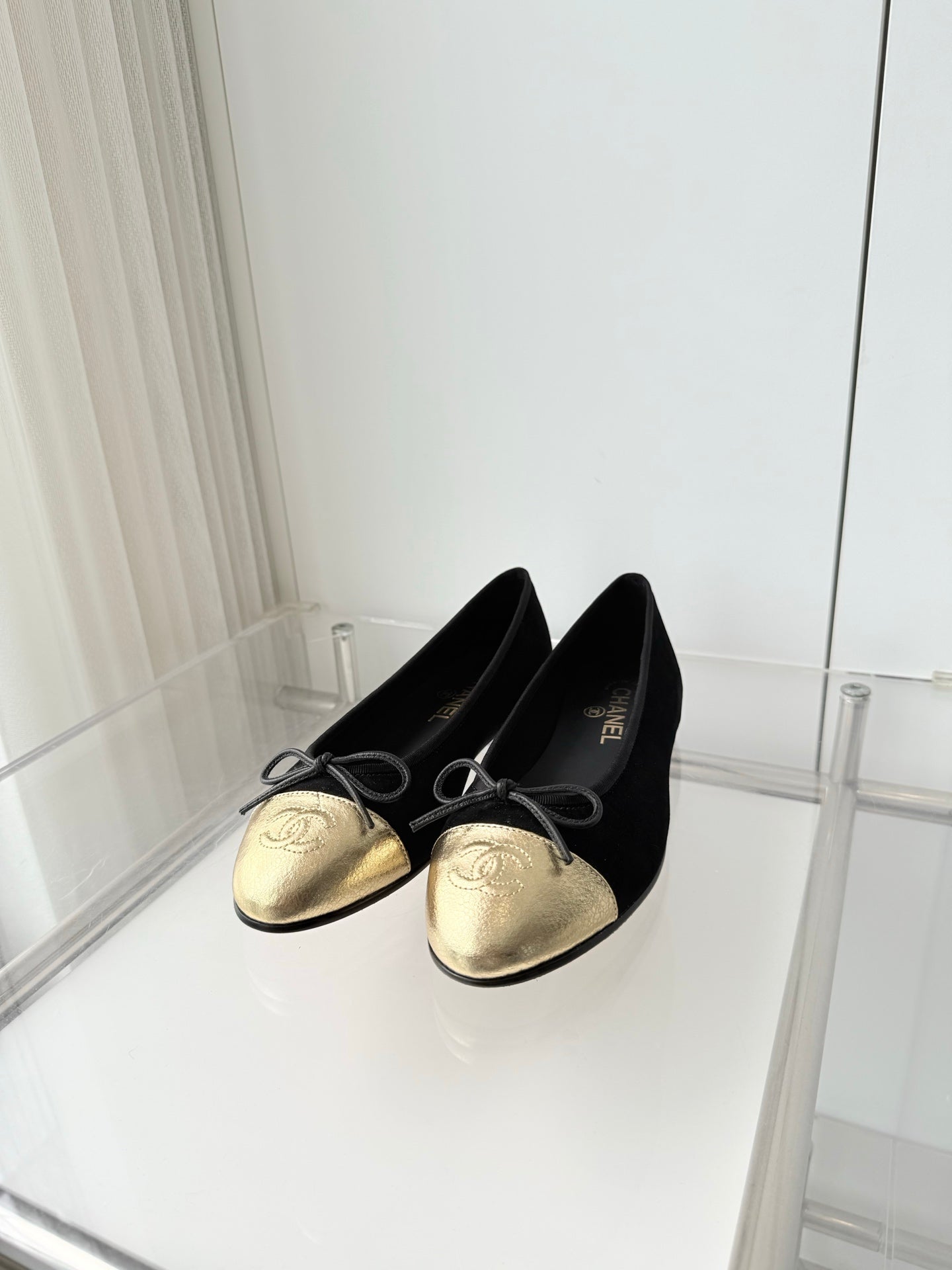 CHANEL 26S BALLET FLATS IN BLACK SUEDE WITH GOLD TOE CAP AND BOW