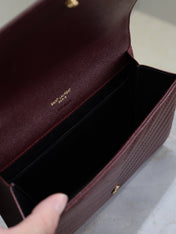 CASSANDRE CLUTCH 21 IN BORDEAUX RED LAMBSKIN GOLD HARDWARE
