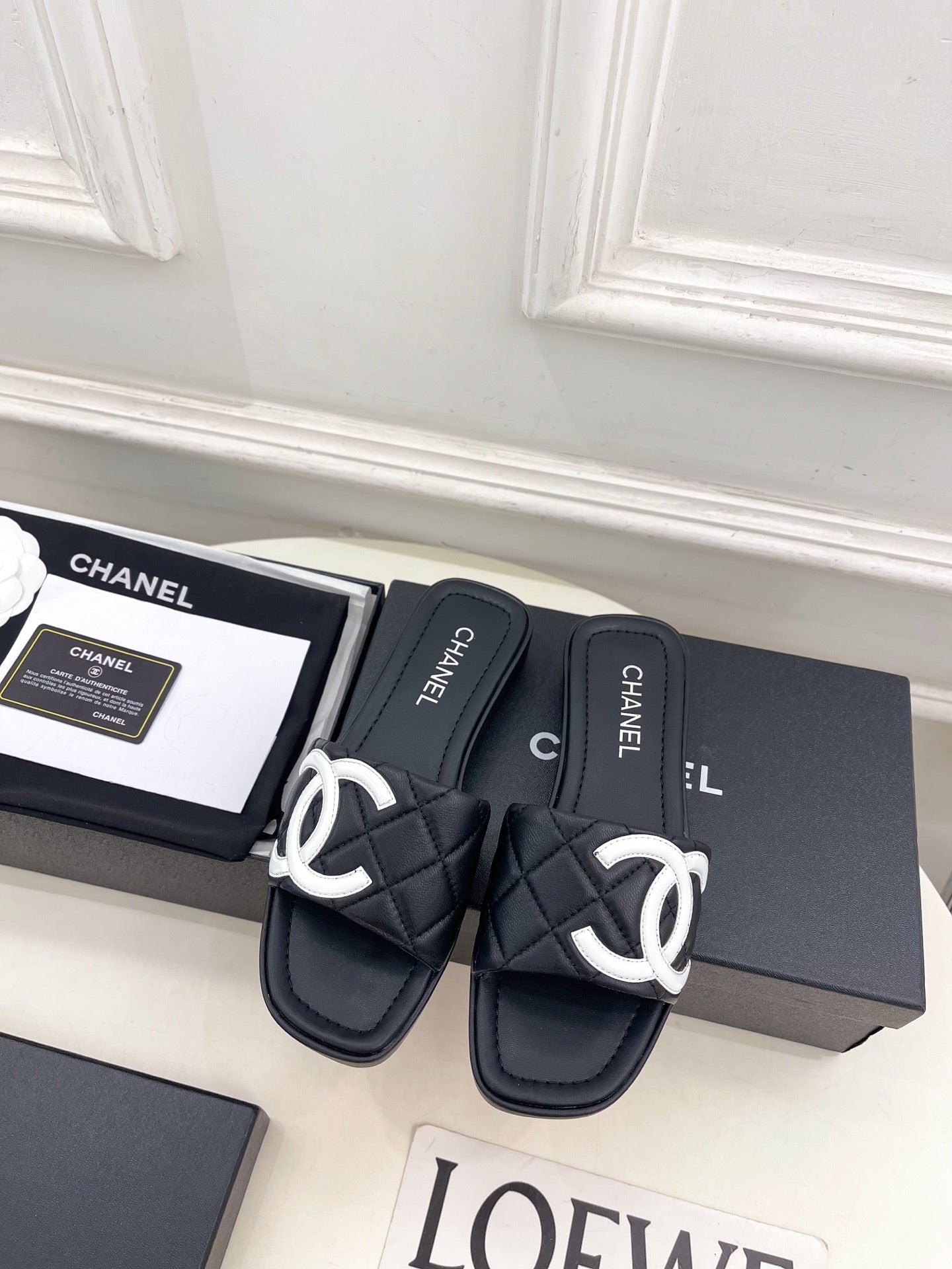 CHANEL 26S FLAT SLIDES IN BLACK LAMBSKIN WITH WHITE CC LOGO