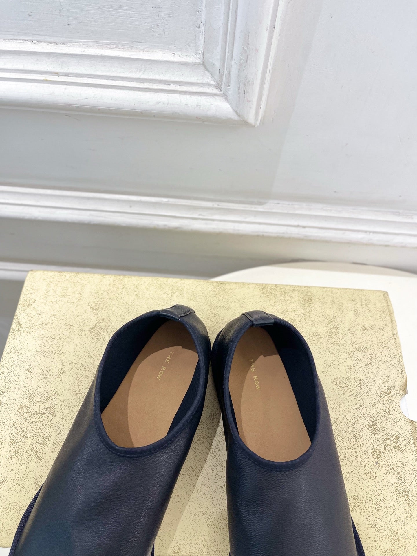 THE ROW 26S SLIP-ON FLATS IN BLACK NAPPA CALFSKIN